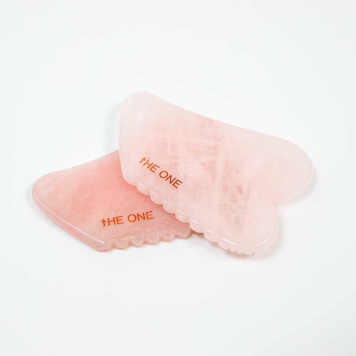 Rose quartz gua sha tools used in Korean facial massage at THE ONE Clinic in Austin